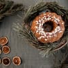 Bundt Cake on Wooden Plate with Pine Leaves