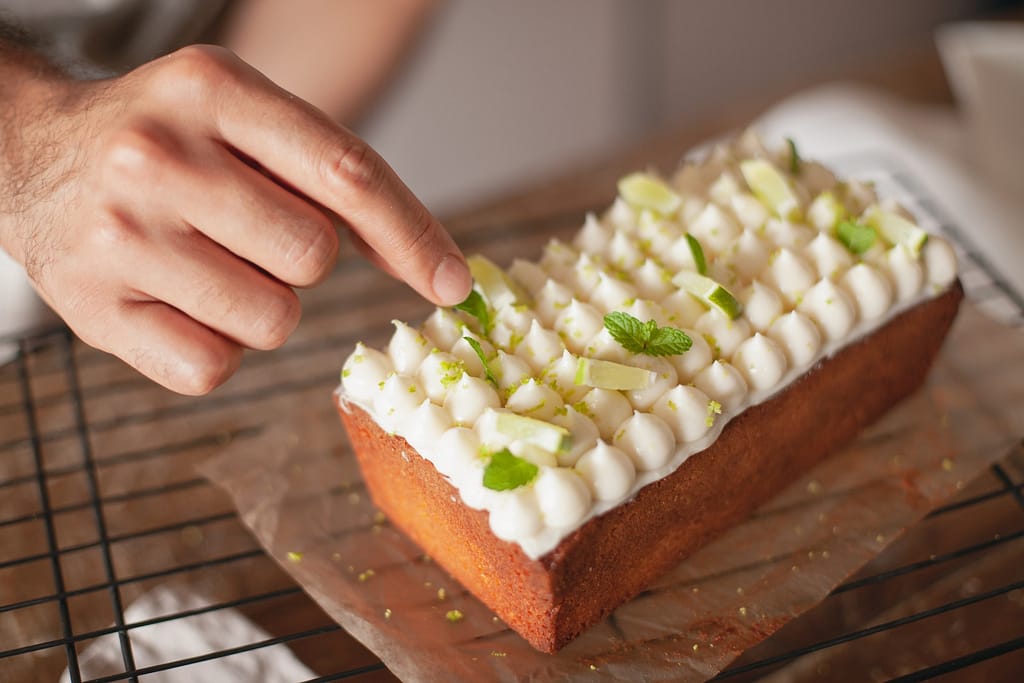 Cake with White Frosting and Mint Leaves